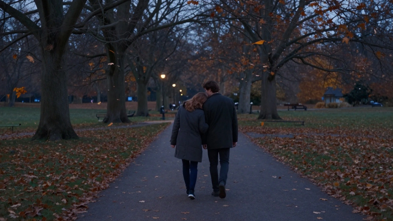 A couple walking hand in hand through Hyde Park at dusk after their massage, heads gently touching, leaves falling around them in the quiet evening.