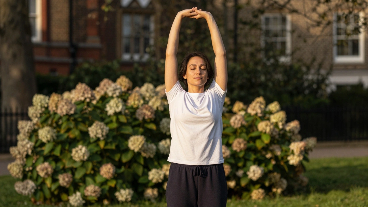 Person stretching arms high wearing loose clothes in park